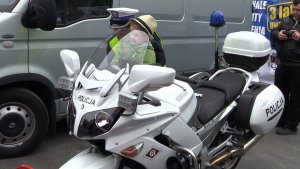 Nadkomisarz Marzena Kwasikowska z katowickiej drogówki prezentuje motocykl dwuletniej uczestniczce imprezy motoryzacyjnej przy katowickim Spodku