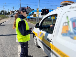 zdjęcie kolorowe: katowicka policjantka rozmawiająca z kierowca samochodu osobowego podczas działań &quot;Zapora życia&quot;